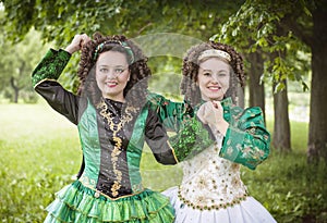 Two young beautiful girl in irish dance dress posing outdoor