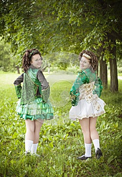 Two young beautiful girl in irish dance dress posing outdoor