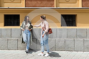 Two young beautiful smiling hipster female in trendy summer clothes. Sexy carefree women friends posing in the street. Positive