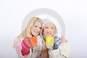 Two Young beautiful winter girls with tea cup