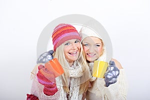 Two Young beautiful winter girls with tea cup