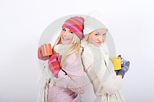 Two Young beautiful winter girls with tea cup