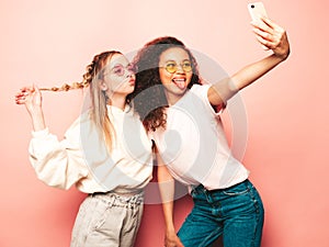 Two young beautiful women posing in studio