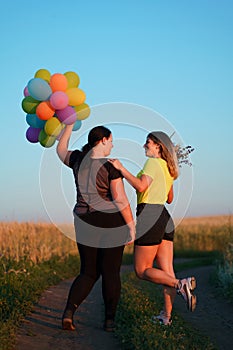 Two young best friends walking down a country road