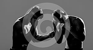 Two young boxers facing each other in a match. Two men boxers boxing on isolated silhouette background. Two men