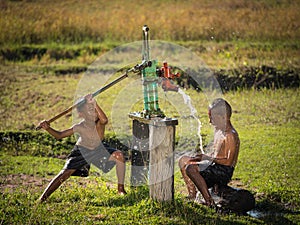 Two young boy rocking groundwater bathe in the hot days.