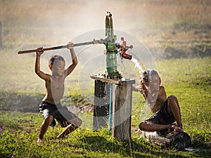 Two young boy rocking groundwater bathe in the hot days. photo