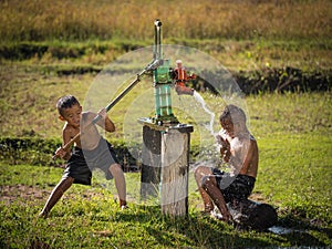 Two young boy rocking groundwater bathe in the hot days. photo