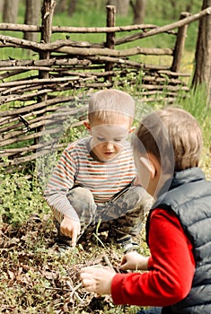 Two young boys discussing lighting a campfire