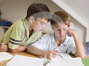 Two Young Boys Doing Their Homework Together