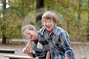 Two young boys laughing and giggling.