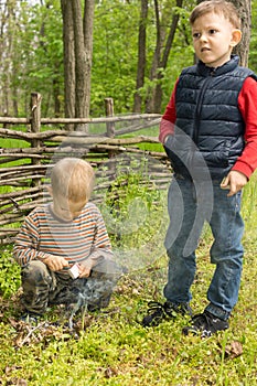 Two young boys learning survival skills