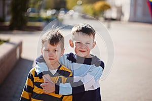 Two young boys outdoors smiling and laugh. Concept friendship