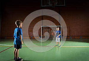 Two young boys playing with a basketball