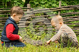 Two young boys playing at lighting a campfire