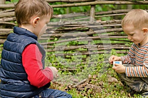 Two young boys playing with matches