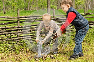 Two young boys putting out a fire