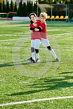 Two young boys, wearing soccer gear