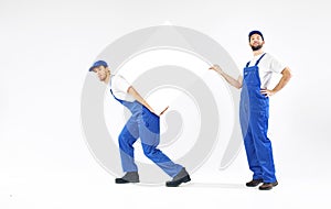 Two young builders holding a board