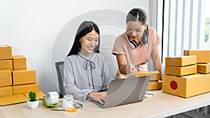 Two young business woman entrepreneur are talking with client on laptop