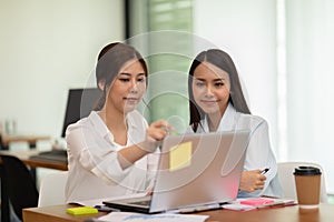 two young business woman Startup coworkers working together to get ideas and marketing at office