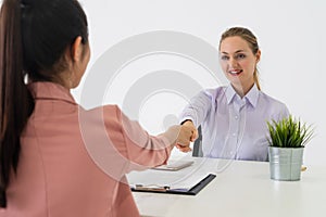 Two young business women meeting for interview.