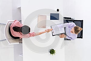 Two young business women meeting for interview.