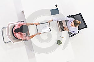 Two young business women meeting for interview.