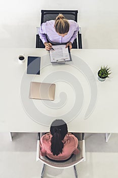 Two young business women meeting for interview.