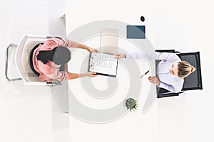 Two young business women meeting for interview.