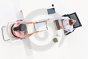 Two young business women meeting for interview.