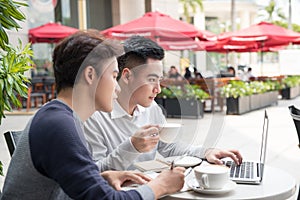 Two young businessman having a successful meeting at restaurant.