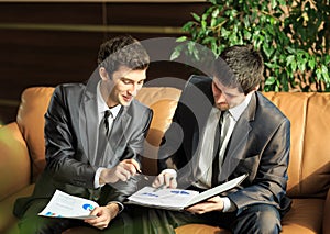 Two young businessmen discussing project