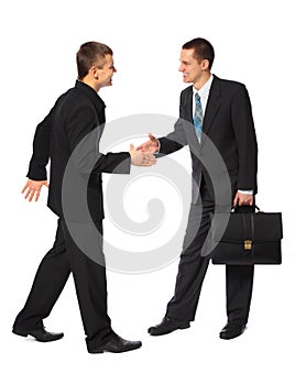 Two young businessmen greet