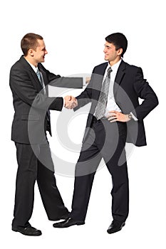 Two young businessmen greet