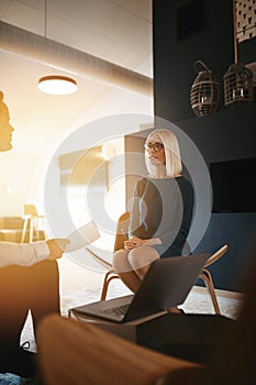 Two young businesspeople discussing work together in an office