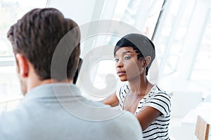 Two young businesspeople having meeting