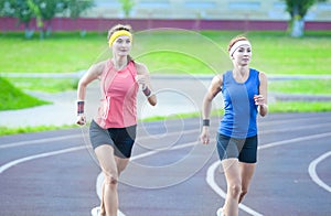 Two Young Caucasian Athletes Running Closely to Each Other