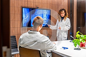 Doctors examining an x-ray image and talking in the hospital