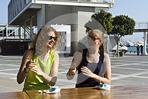 Two girls in seaside street cafe