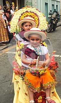 Portrait of Two Little Girls in Costumes during the Pase Del Nino Parade in Cuenca Ecuador