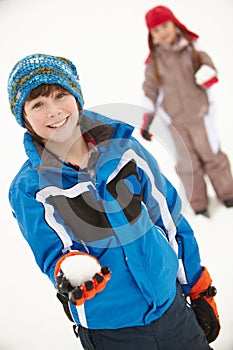 Two Young Children Having Snowball Fight