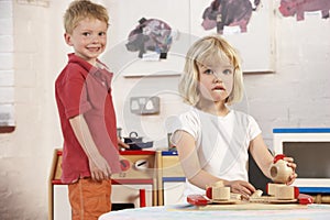 Two Young Children Playing Together at Montessori/