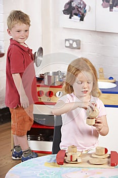 Two Young Children Playing Together at Montessori/