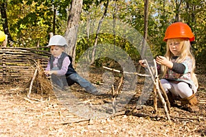Two young children pretending to be builders photo