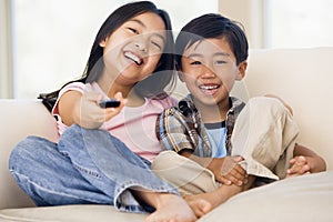 Two young children in room with remote control