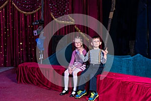 Two young children waiting for a performance