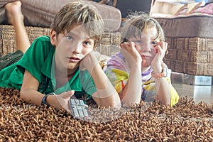 Two young children watching tv