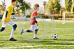 Two young children, wearing colorful soccer