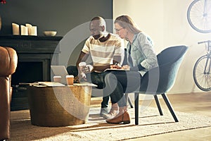 Two young colleagues at work together in a stylish office